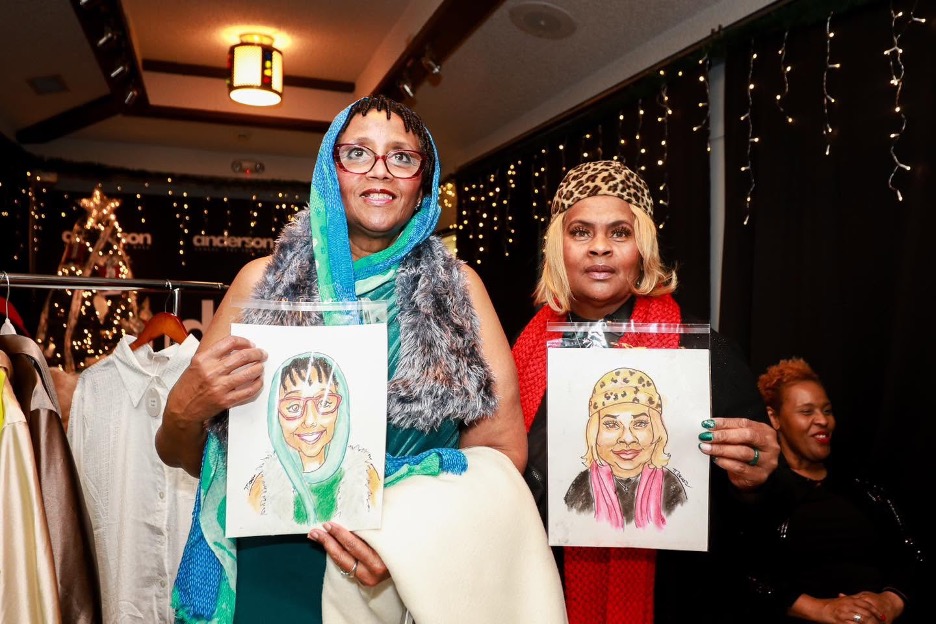 Guests with their finished caricatures